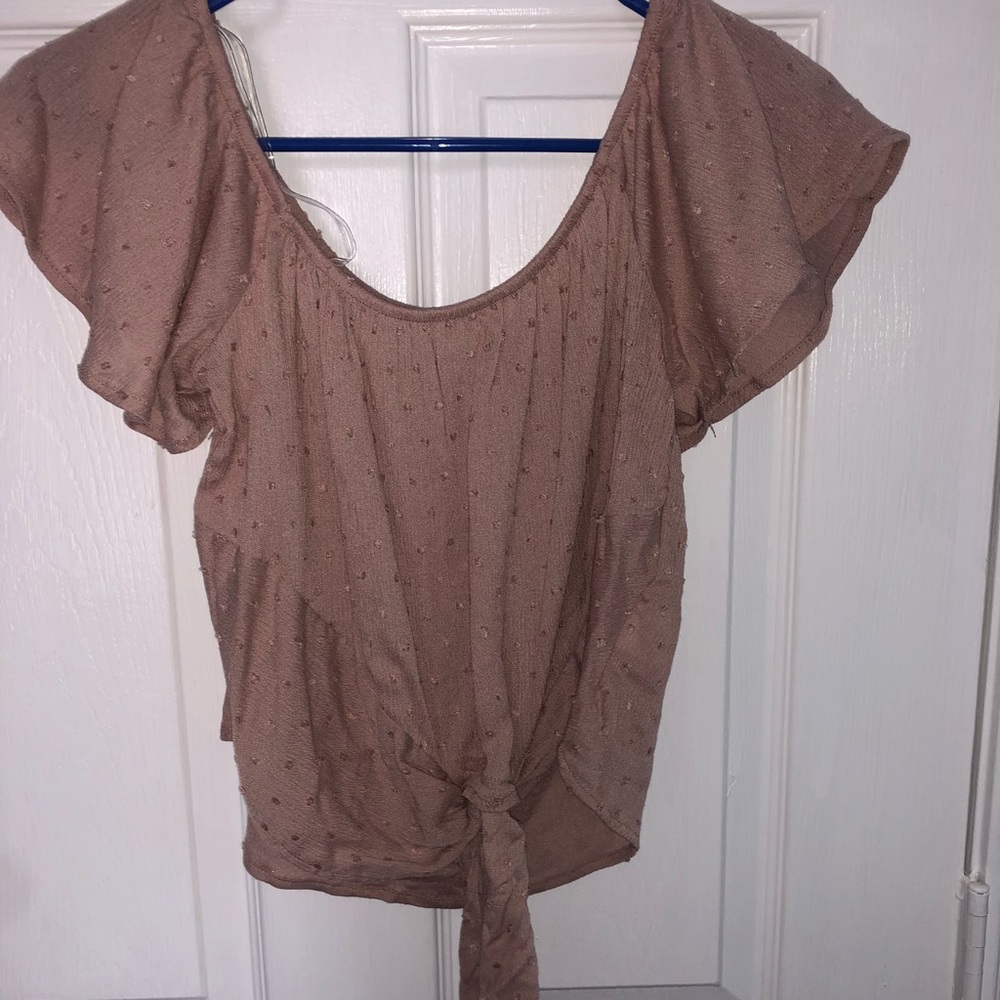 light pink top with knot off the shoulder